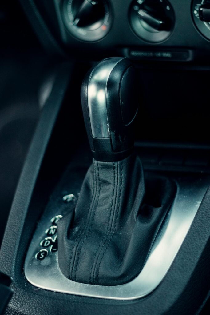 Detailed view of a sleek automatic car shifter in a modern vehicle interior.